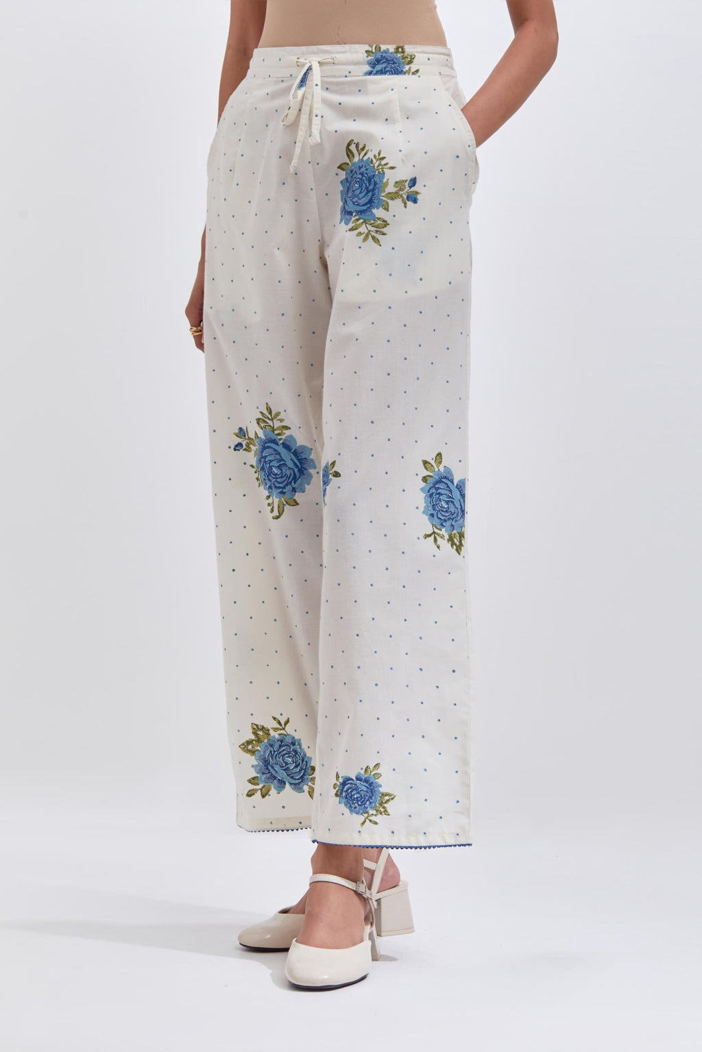 Off white cotton straight pants with all-over blue & green floral hand block print.