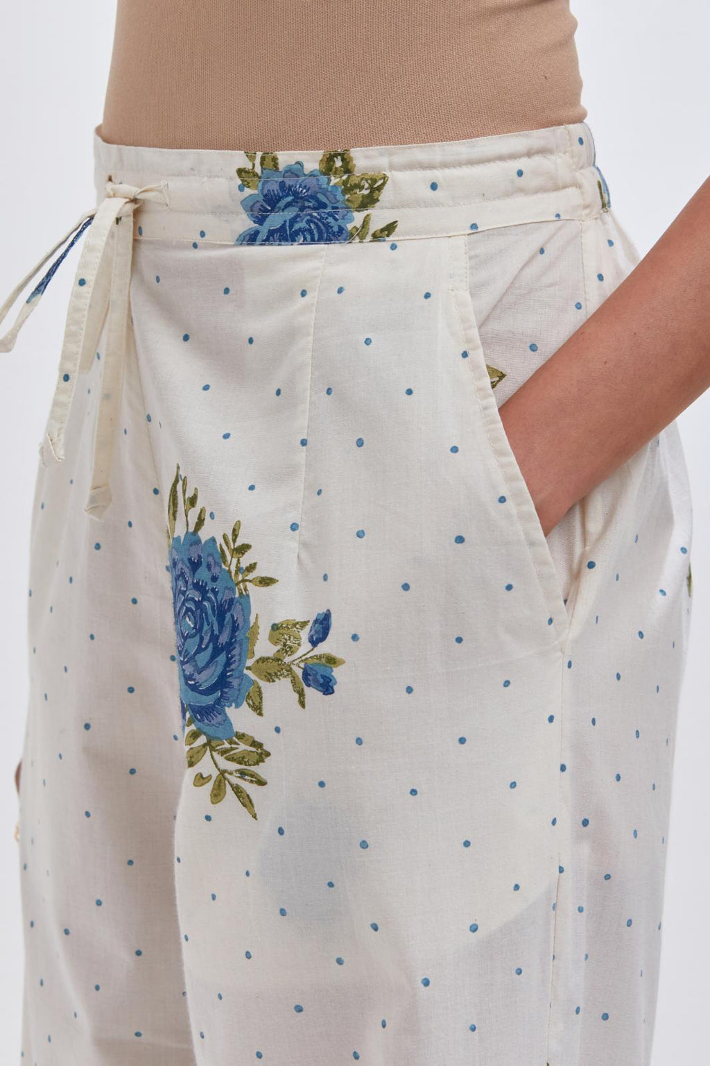 Off white cotton straight pants with all-over blue & green floral hand block print.