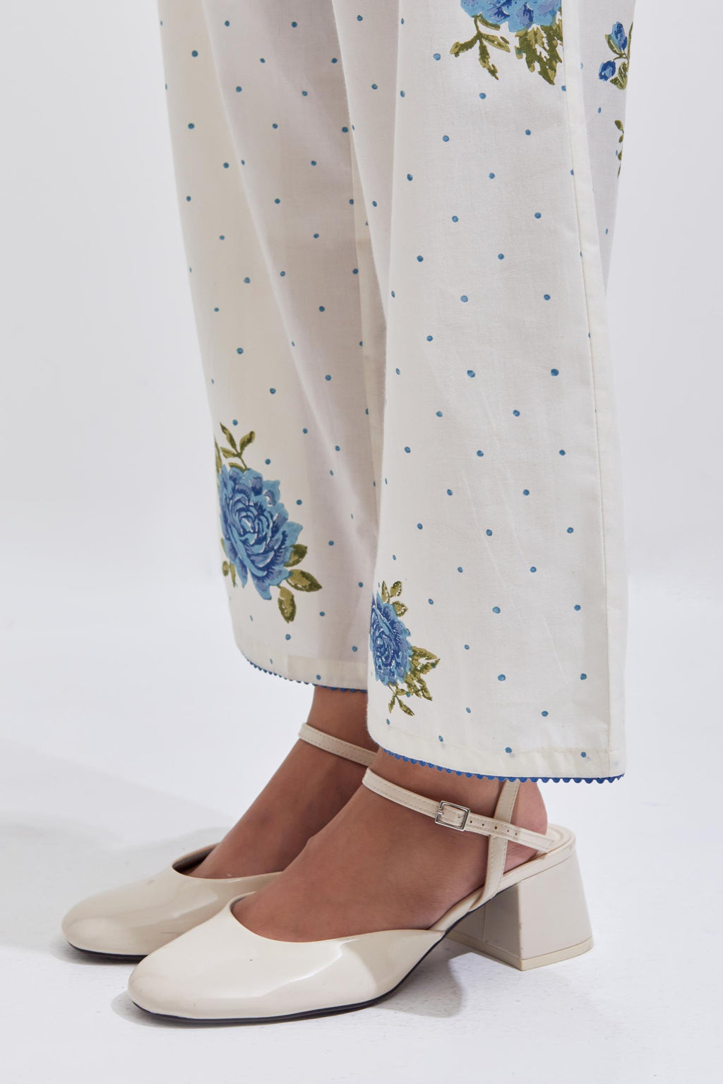 Off white cotton straight pants with all-over blue & green floral hand block print.