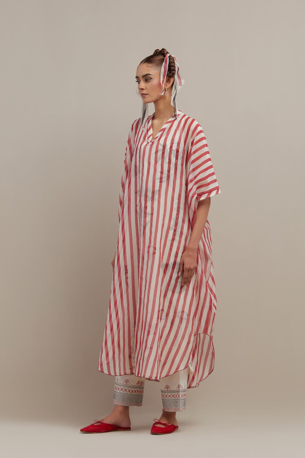 Red & off-white cotton chanderi hand block printed kaftan with round hem, paired with off white straight pants with quilted embroidery at bottom hem.