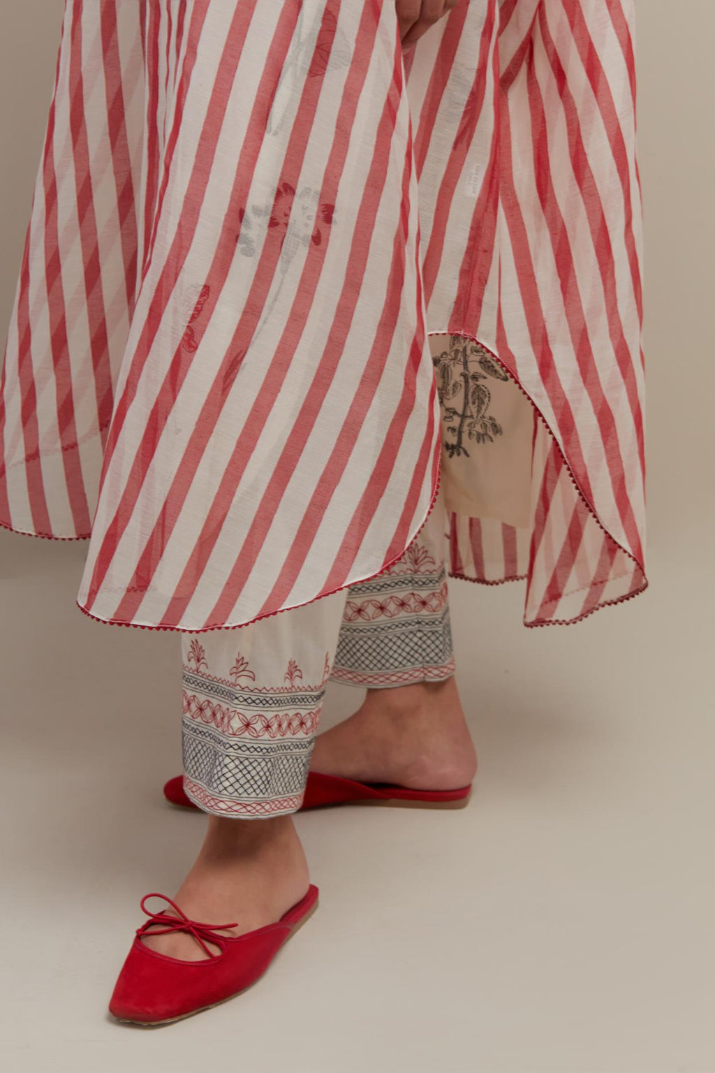 Red & off-white cotton chanderi hand block printed kaftan with round hem, paired with off white straight pants with quilted embroidery at bottom hem.