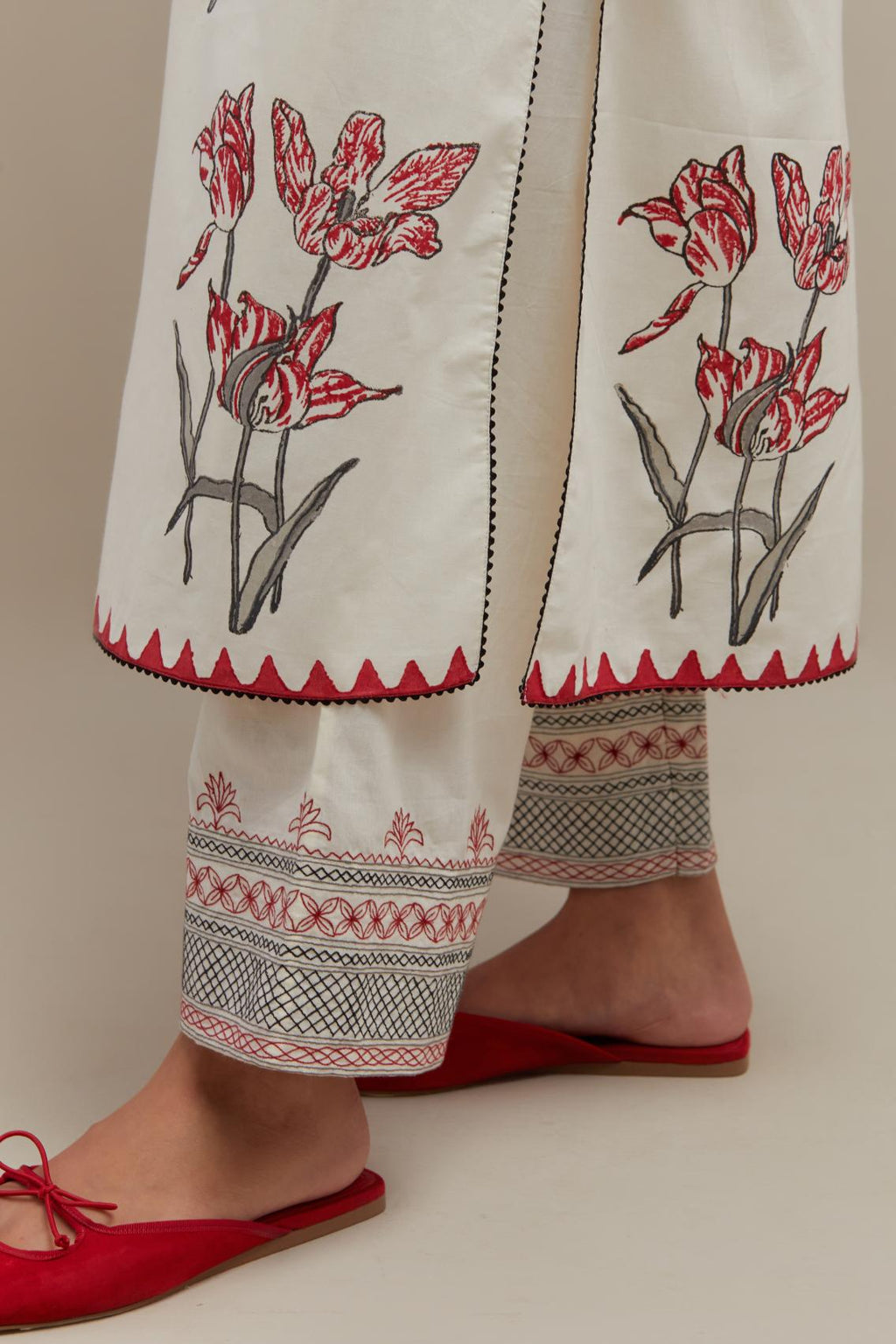 Off white cotton hand block printed kurta set with all-over red & black colored flower.