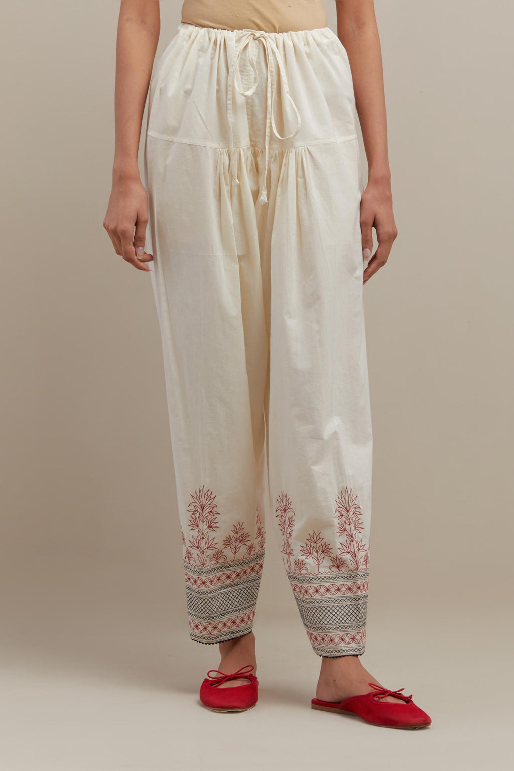 Off white cotton salwar with quilted embroidery at hem.