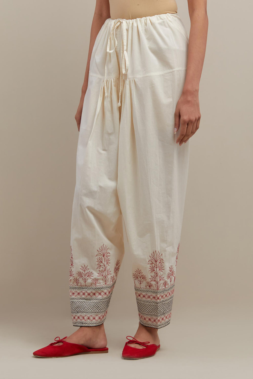 Off white cotton salwar with quilted embroidery at hem.