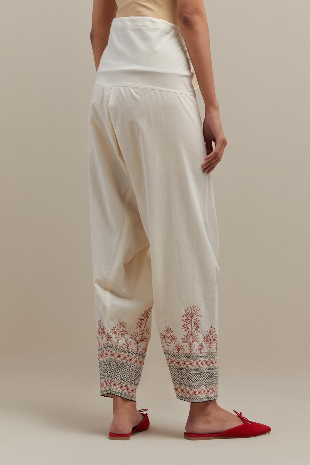 Off white cotton salwar with quilted embroidery at hem.