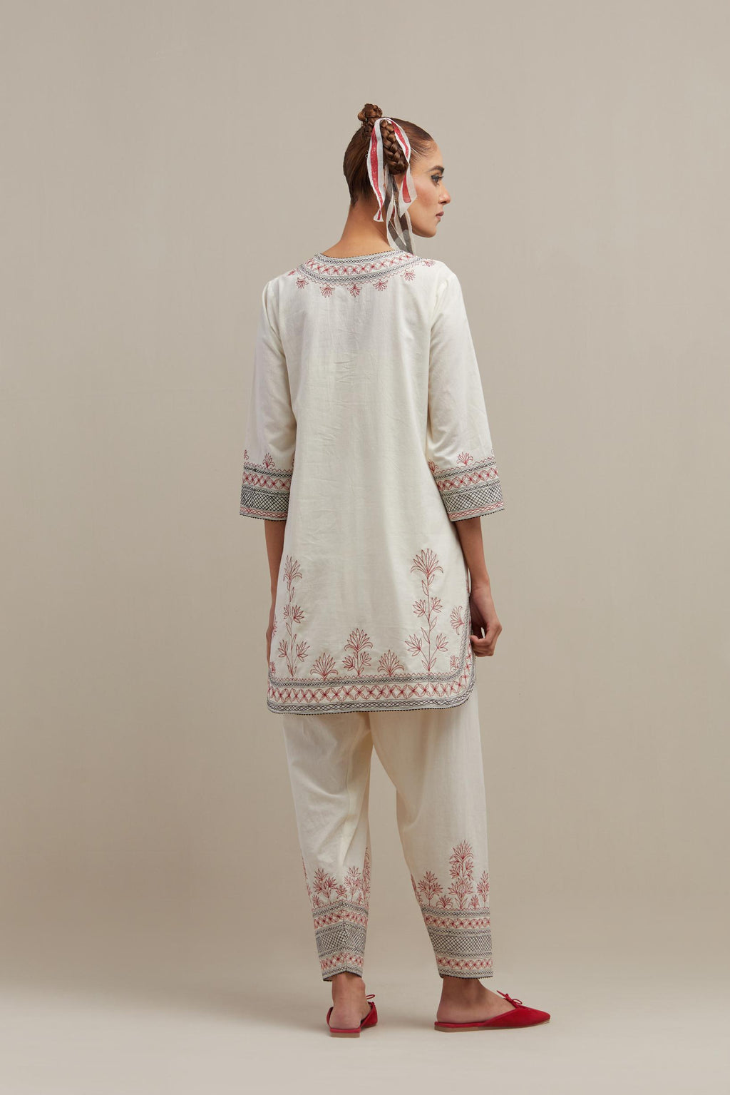 Off white cotton straight short kurta set with red & black embroidery at neck, hem and sleeves.