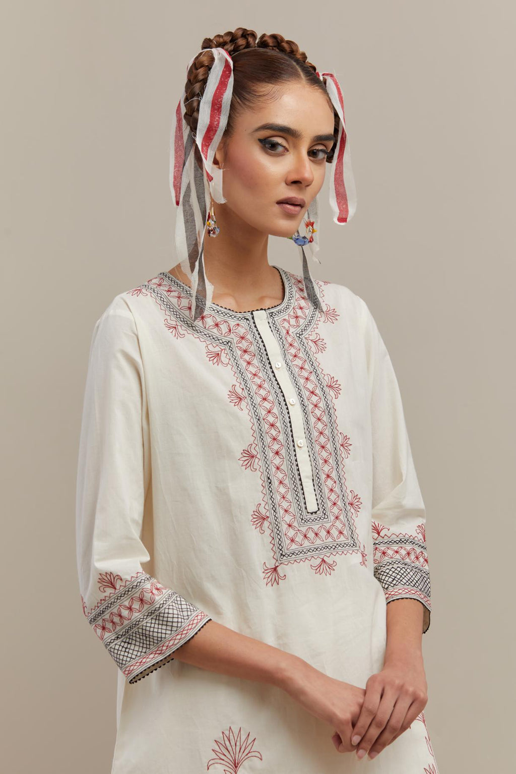 Off white cotton straight short kurta set with red & black embroidery at neck, hem and sleeves.