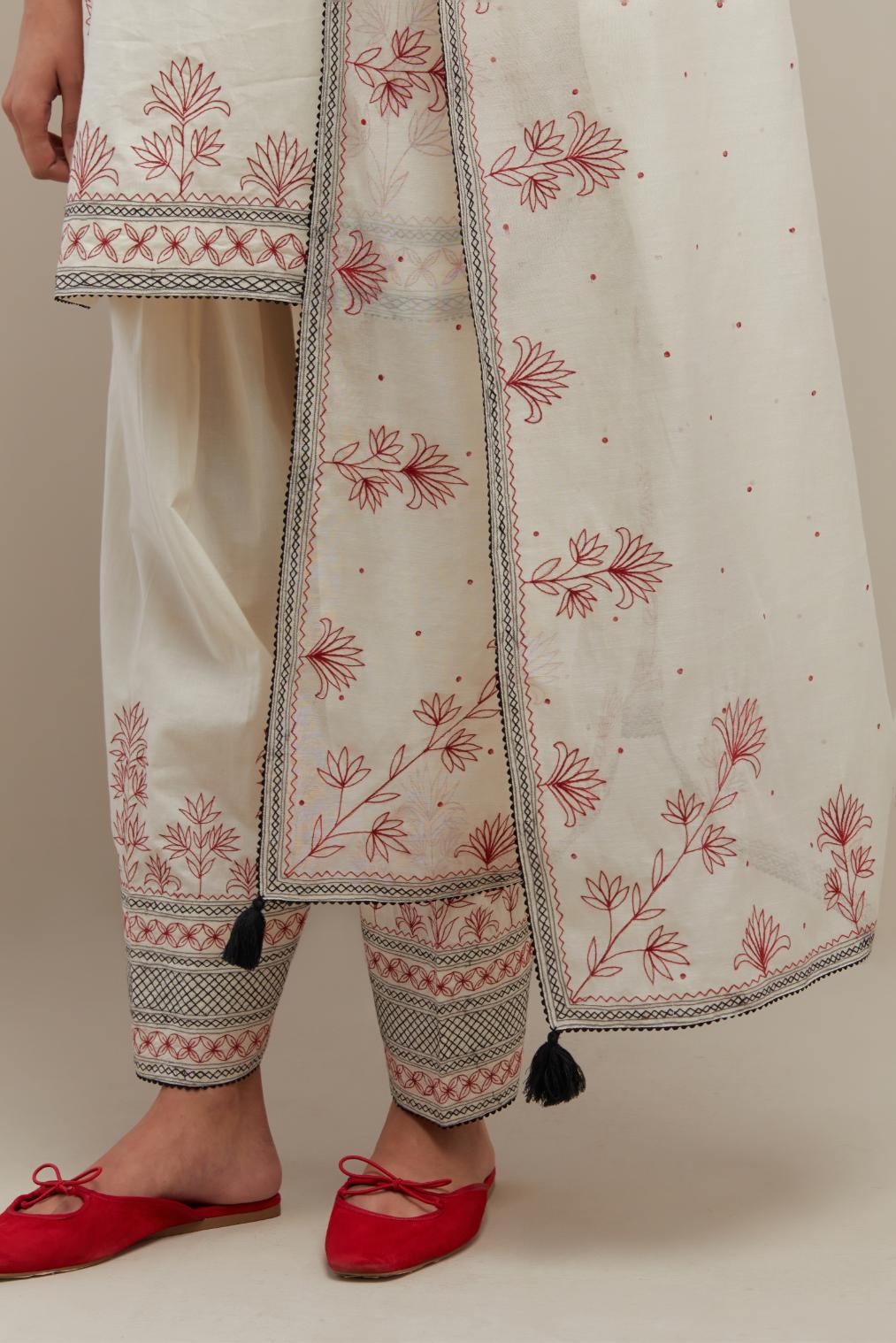 Off white cotton straight short kurta set with red & black embroidery at neck, hem and sleeves.