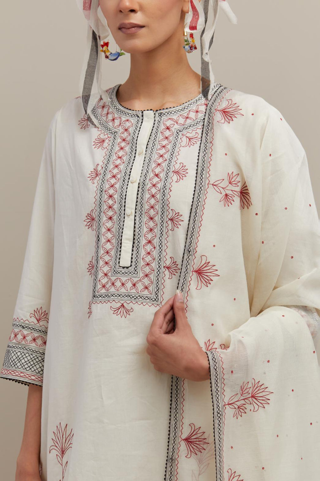 Off white cotton straight short kurta set with red & black embroidery at neck, hem and sleeves.