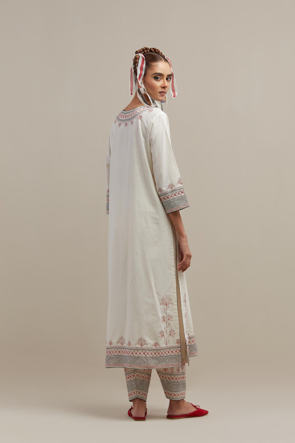 Off white cotton straight kurta set with red & black embroidery at neck, hem and sleeves.