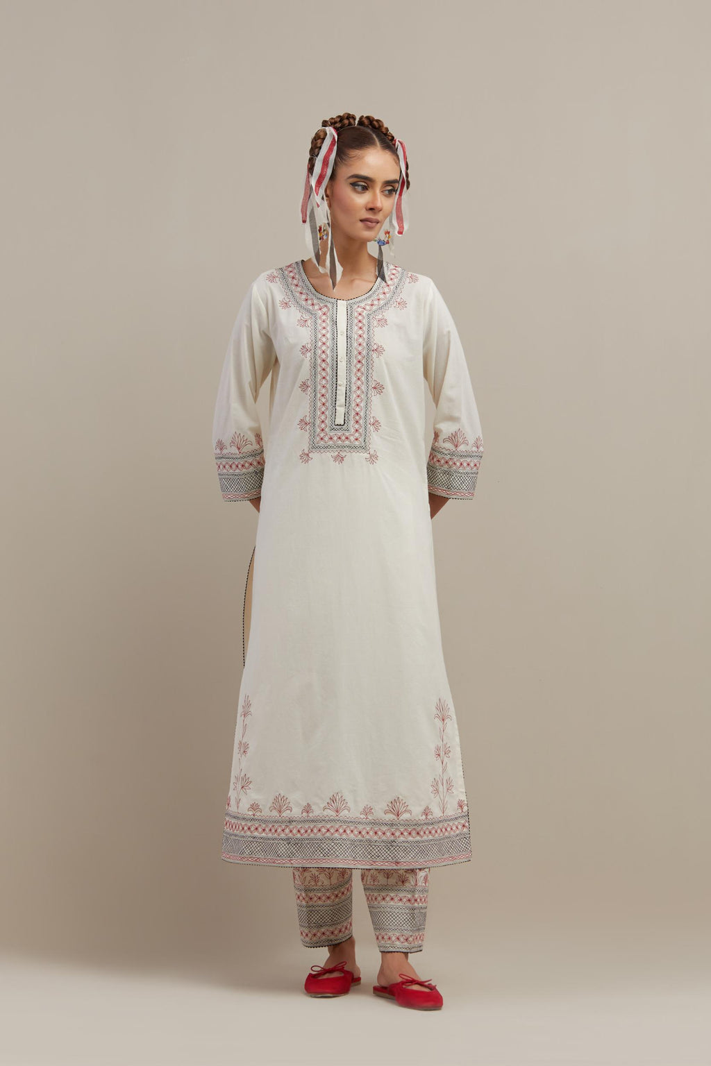 Off white cotton straight kurta set with red & black embroidery at neck, hem and sleeves.