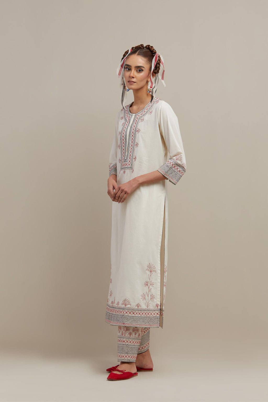 Off white cotton straight kurta set with red & black embroidery at neck, hem and sleeves.