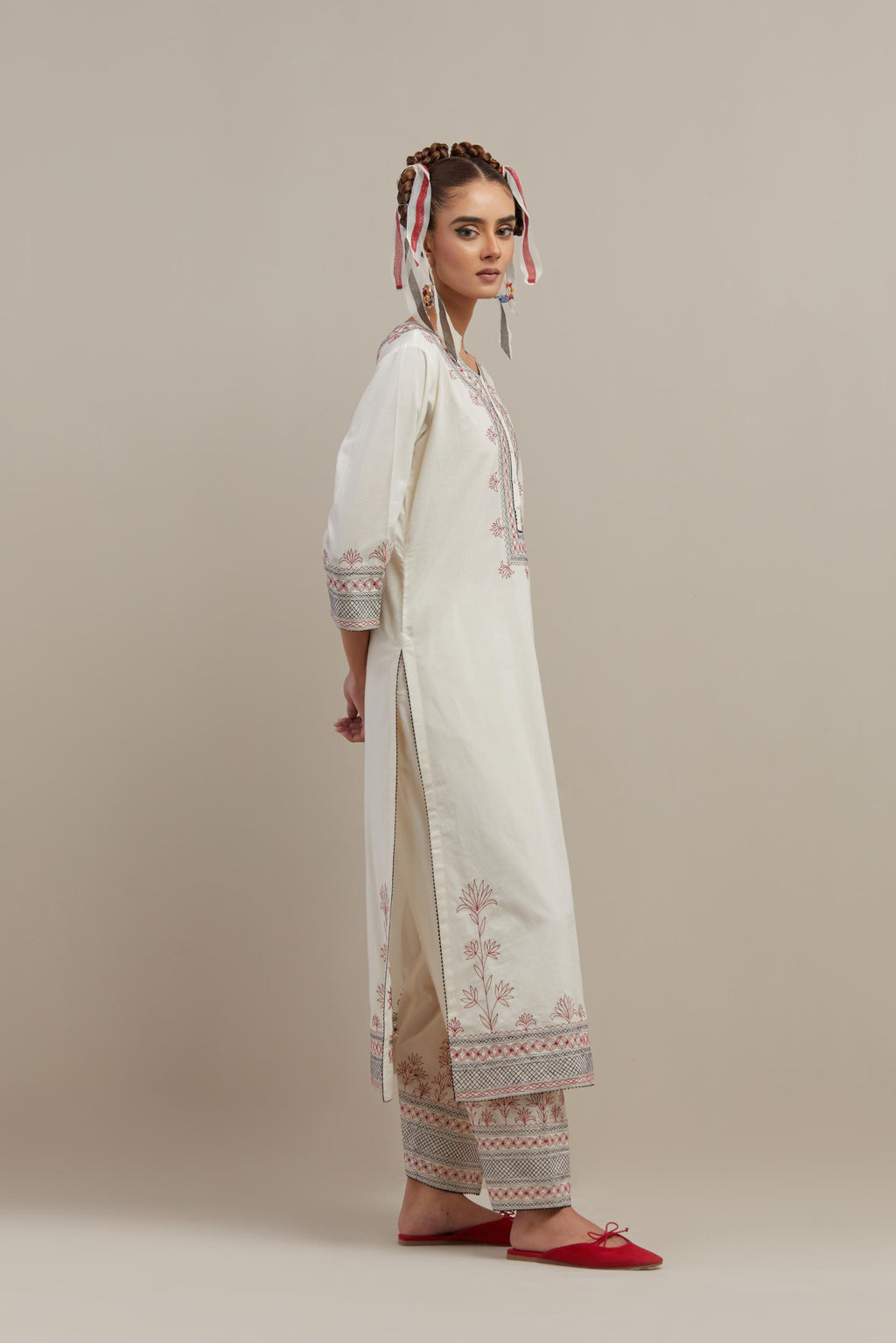 Off white cotton straight kurta set with red & black embroidery at neck, hem and sleeves.