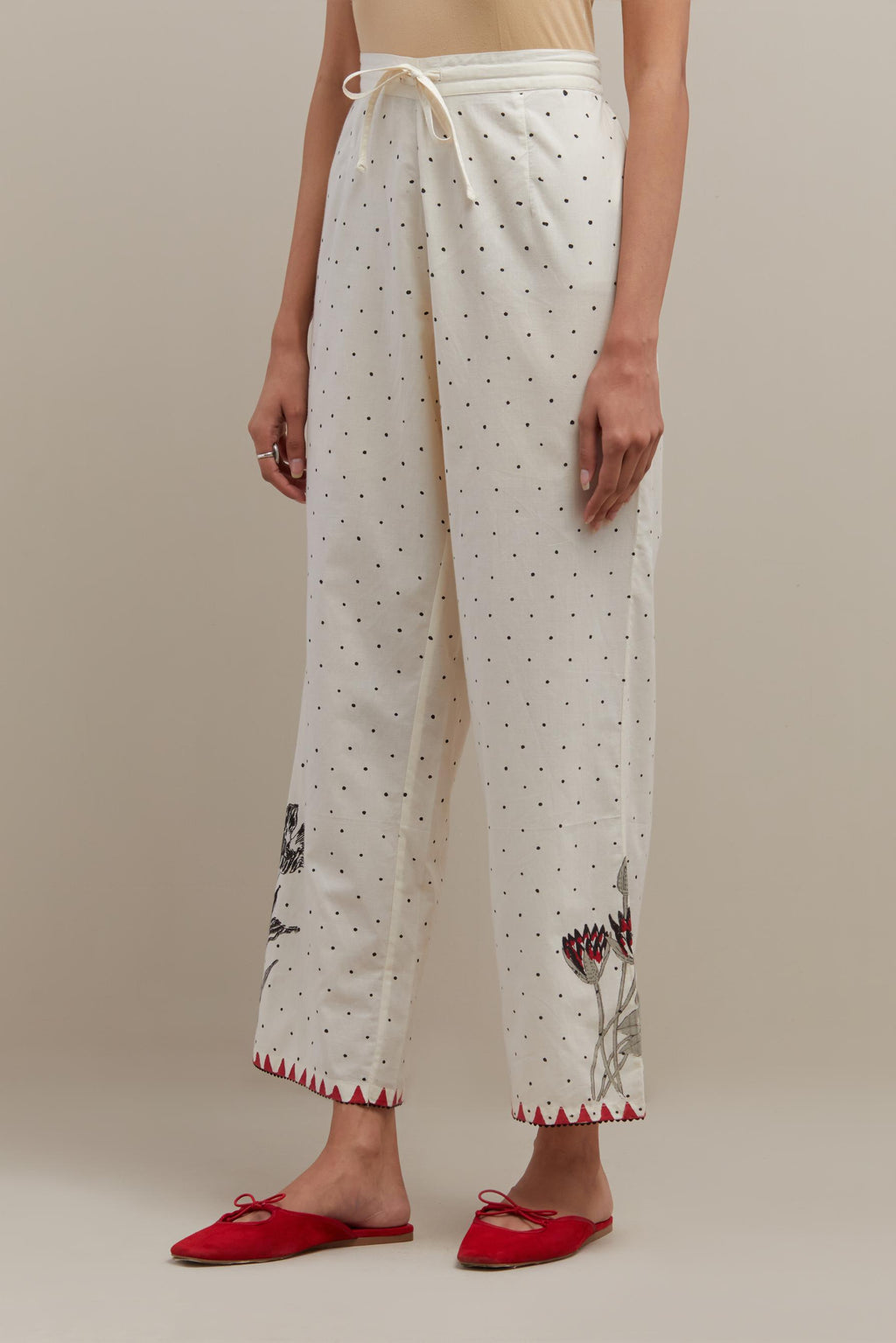 Off white cotton straight pants with all-over black & red hand block print.