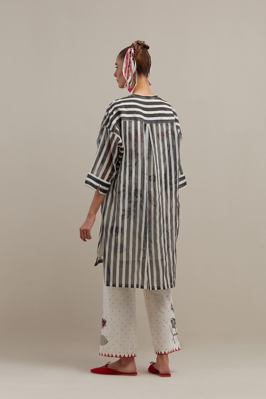 Black & off-white cotton chanderi hand block printed easy fit kurta with band collar neckline, paired with off white cotton straight pants with all-over black & red hand block print.