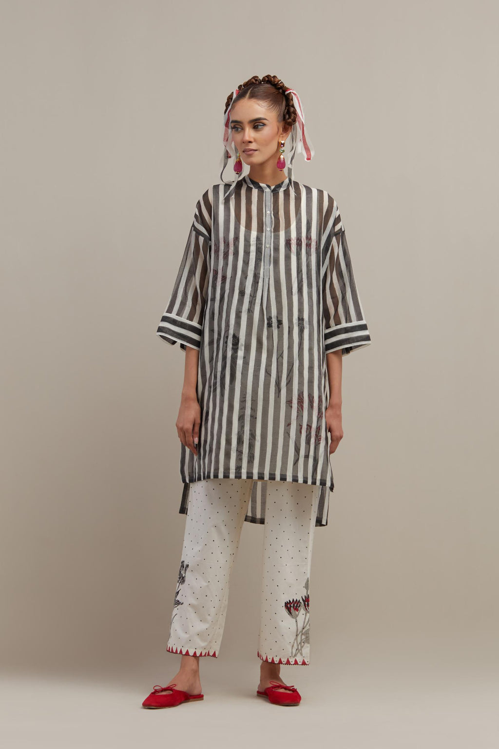 Black & off-white cotton chanderi hand block printed easy fit kurta with band collar neckline, paired with off white cotton straight pants with all-over black & red hand block print.