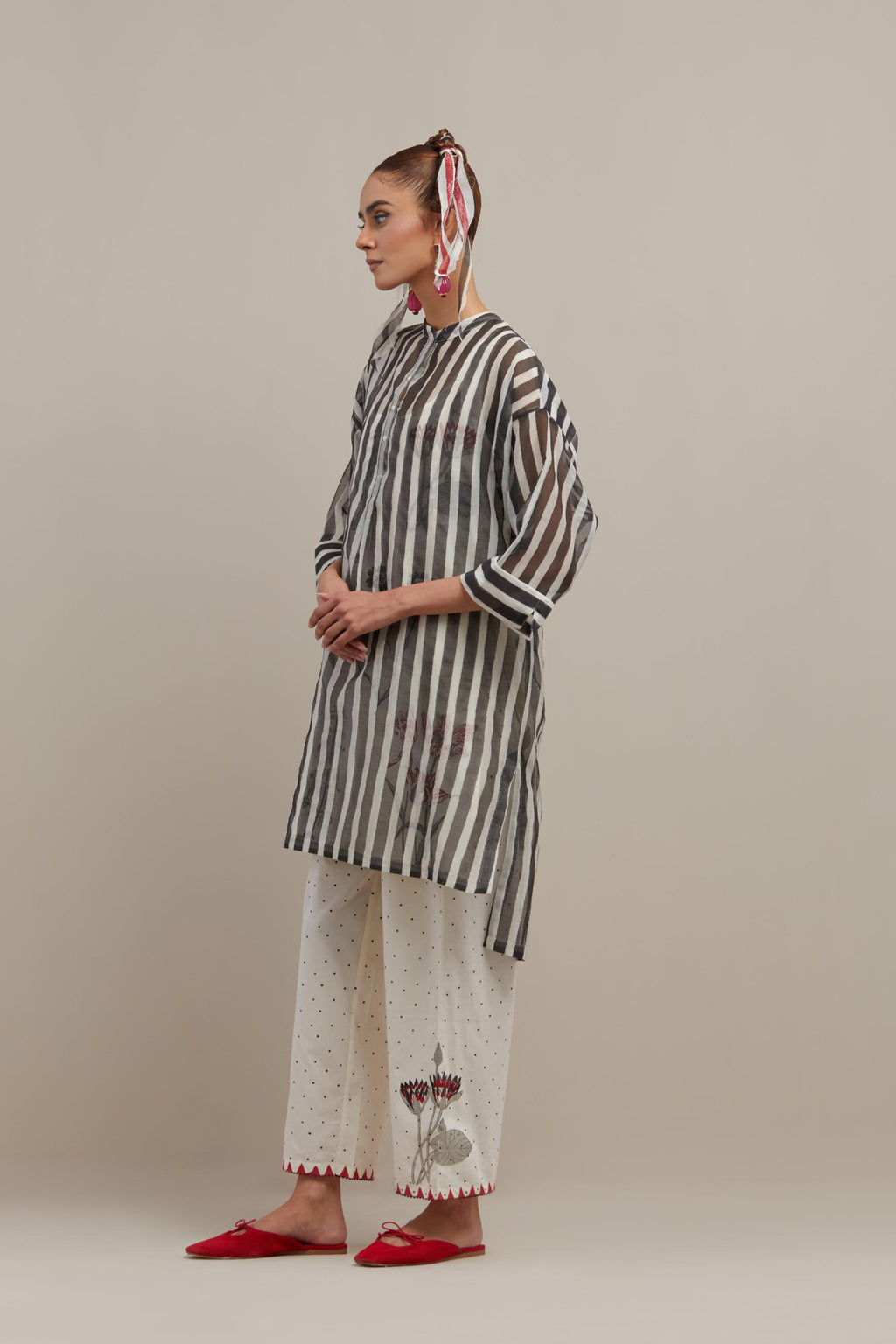 Black & off-white cotton chanderi hand block printed easy fit kurta with band collar neckline, paired with off white cotton straight pants with all-over black & red hand block print.