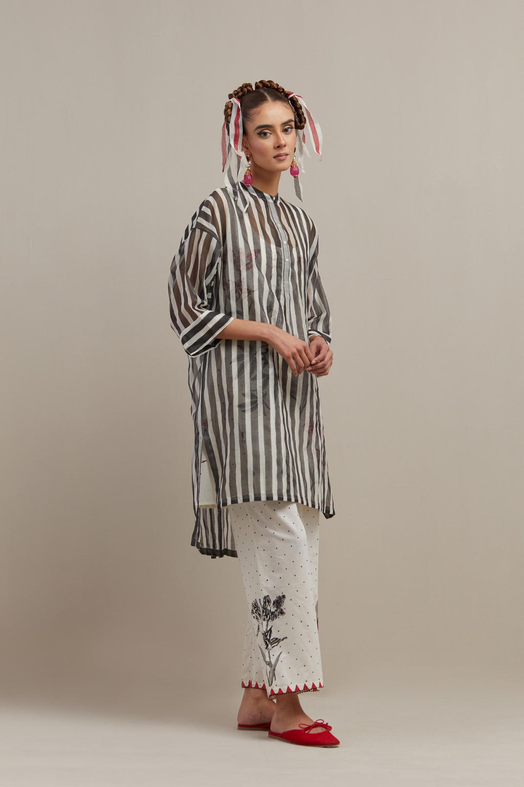 Black & off-white cotton chanderi hand block printed easy fit kurta with band collar neckline, paired with off white cotton straight pants with all-over black & red hand block print.