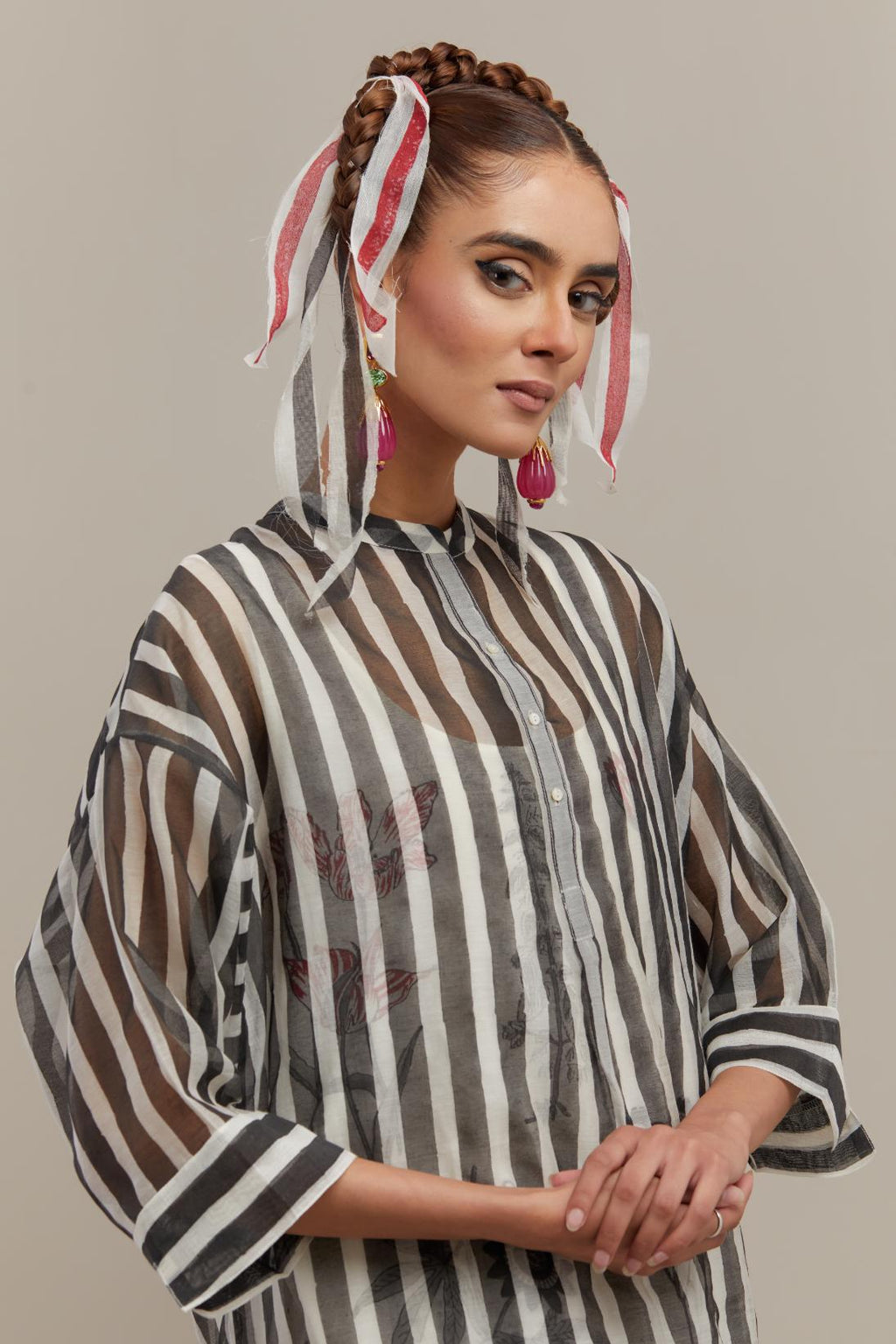 Black & off-white cotton chanderi hand block printed easy fit kurta with band collar neckline, paired with off white cotton straight pants with all-over black & red hand block print.