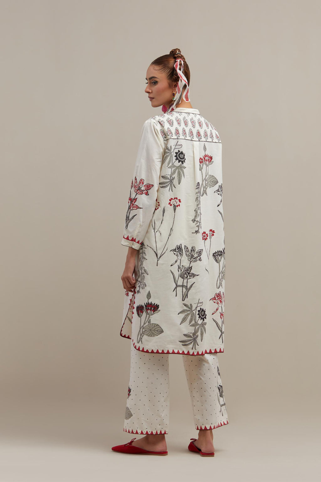 Off white cotton straight short kurta set with all-over red & black colored flower.