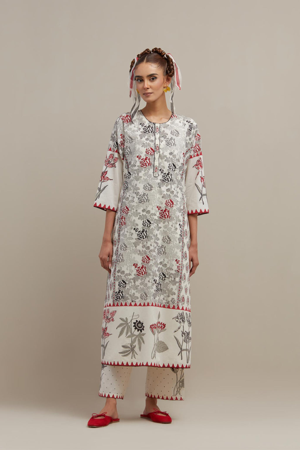 Off white cotton hand block printed straight kurta set with red & black colored flower and border detail at hem.