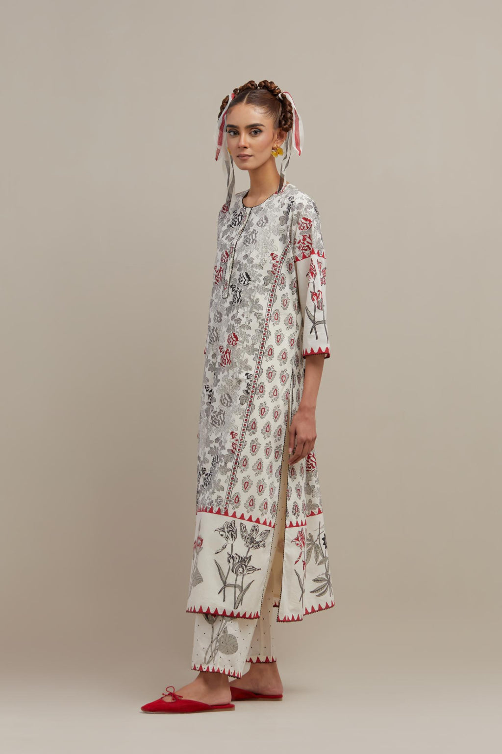 Off white cotton hand block printed straight kurta set with red & black colored flower and border detail at hem.