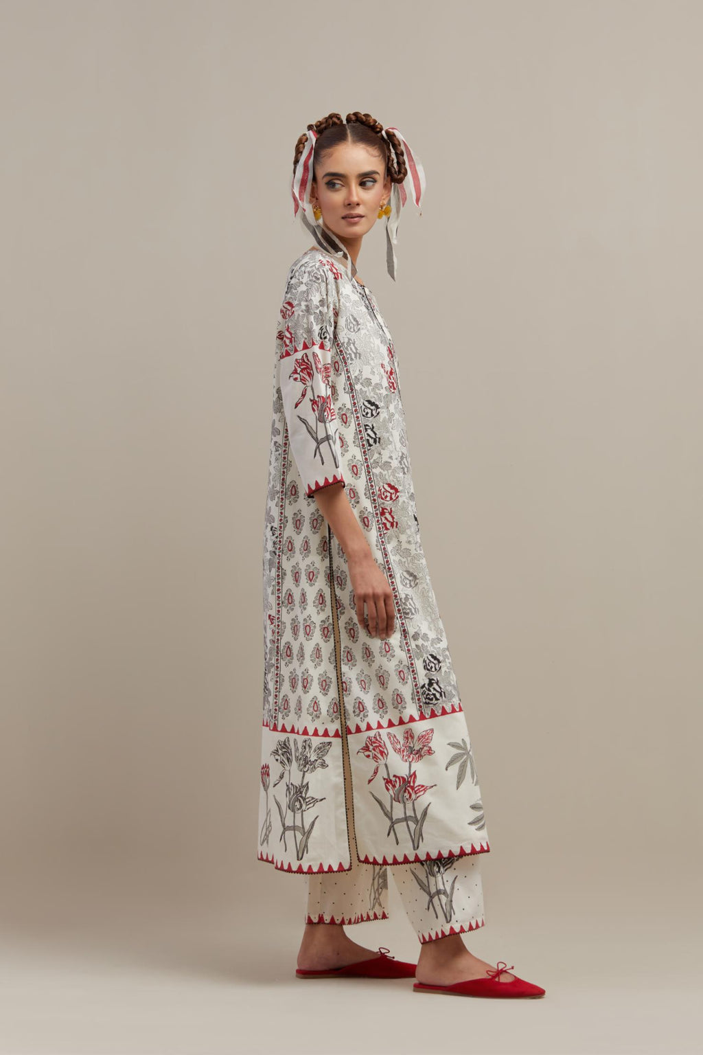 Off white cotton hand block printed straight kurta set with red & black colored flower and border detail at hem.