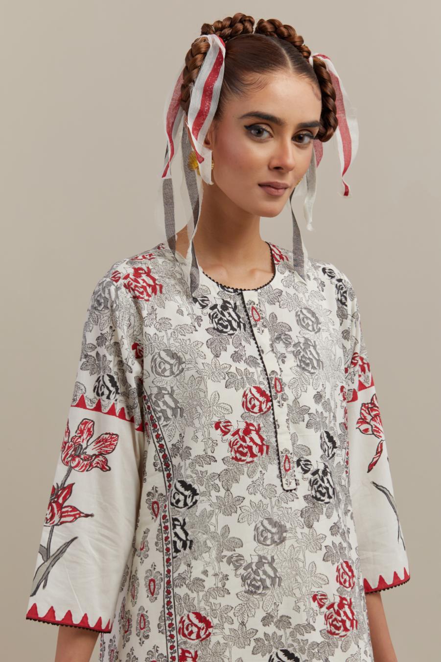 Off white cotton hand block printed straight kurta set with red & black colored flower and border detail at hem.