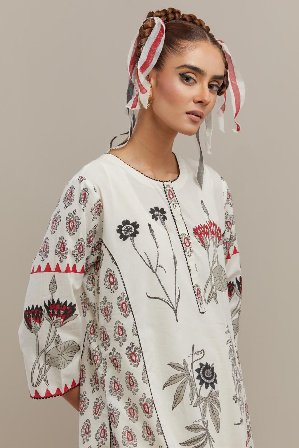 Off white cotton hand-block printed kurta set with side panels highlighted with ricrac.