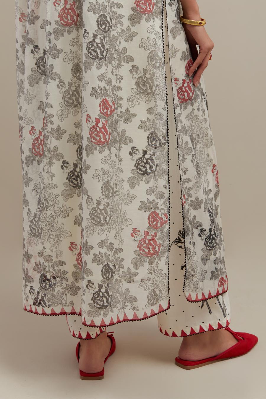 Off white cotton chanderi hand block printed kurta set with pin tucks at yoke and all-over red & black colored flower.