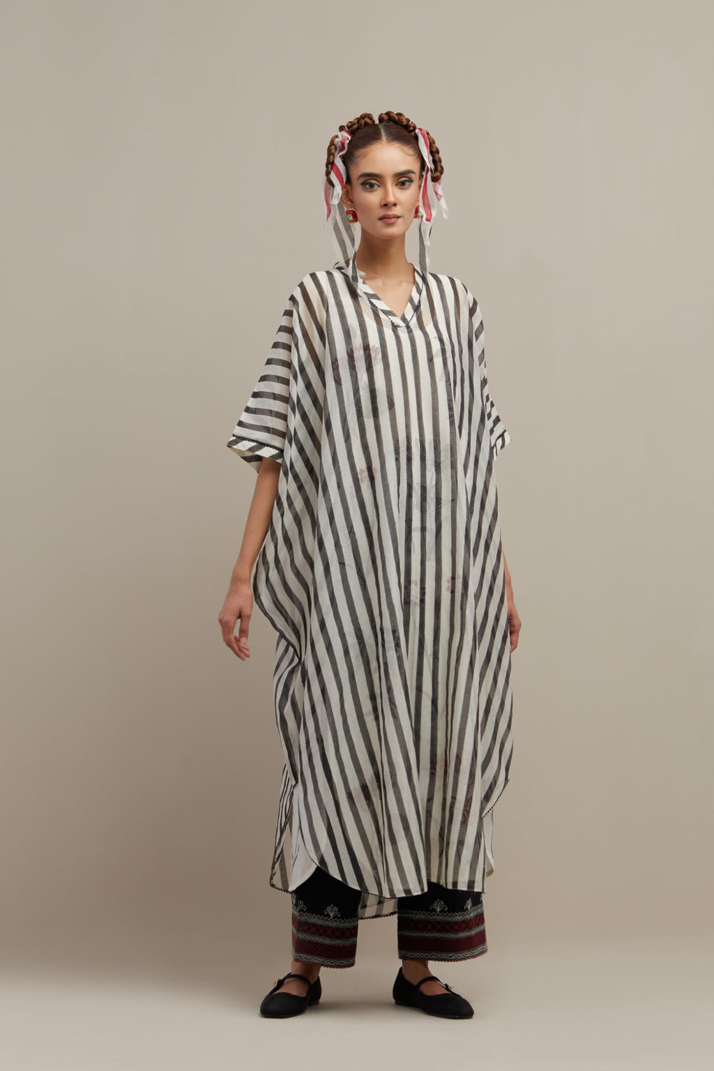 Black & off-white cotton chanderi hand block printed kaftan with round hem, paired with black straight pants with quilted embroidery at bottom hem.