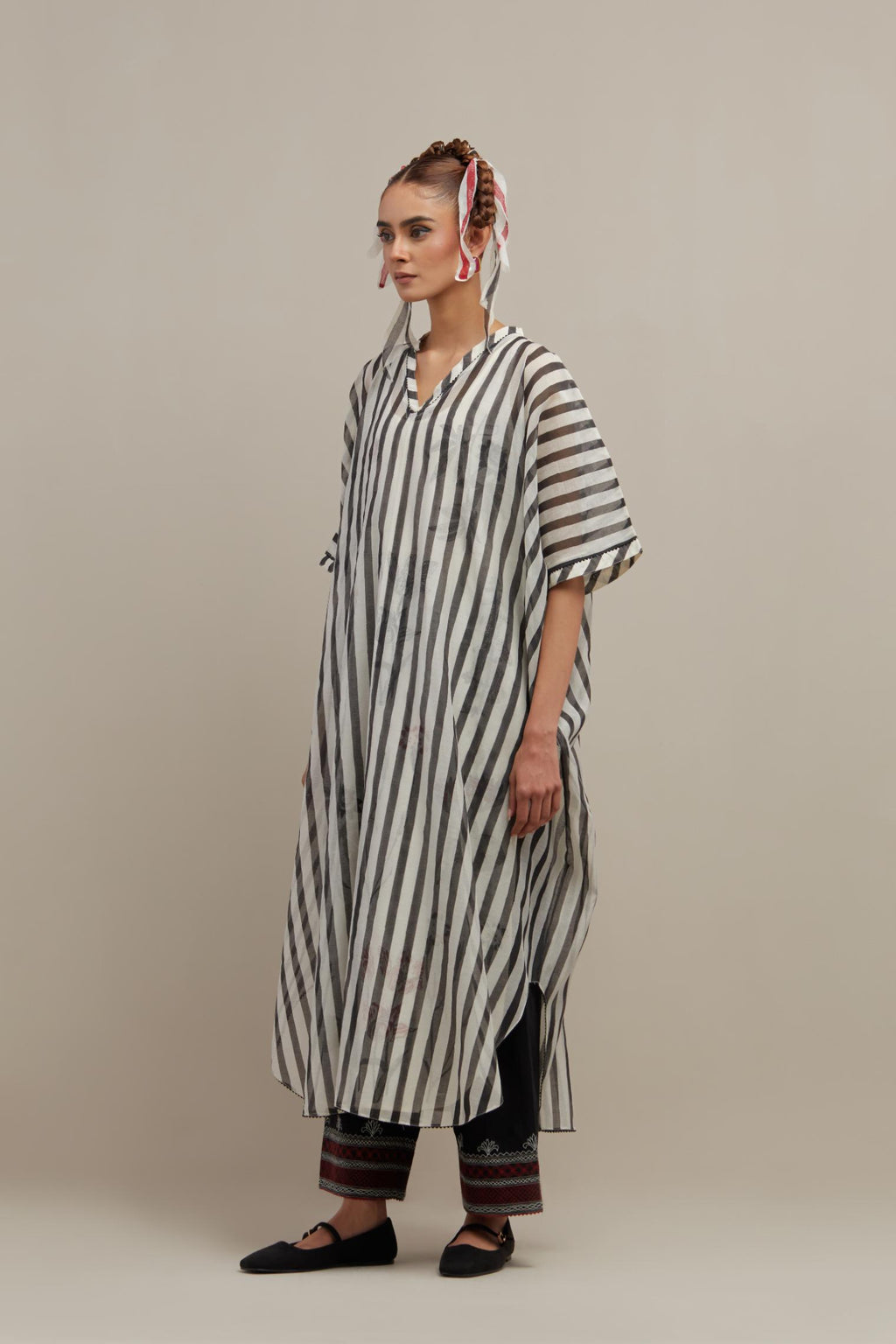 Black & off-white cotton chanderi hand block printed kaftan with round hem, paired with black straight pants with quilted embroidery at bottom hem.