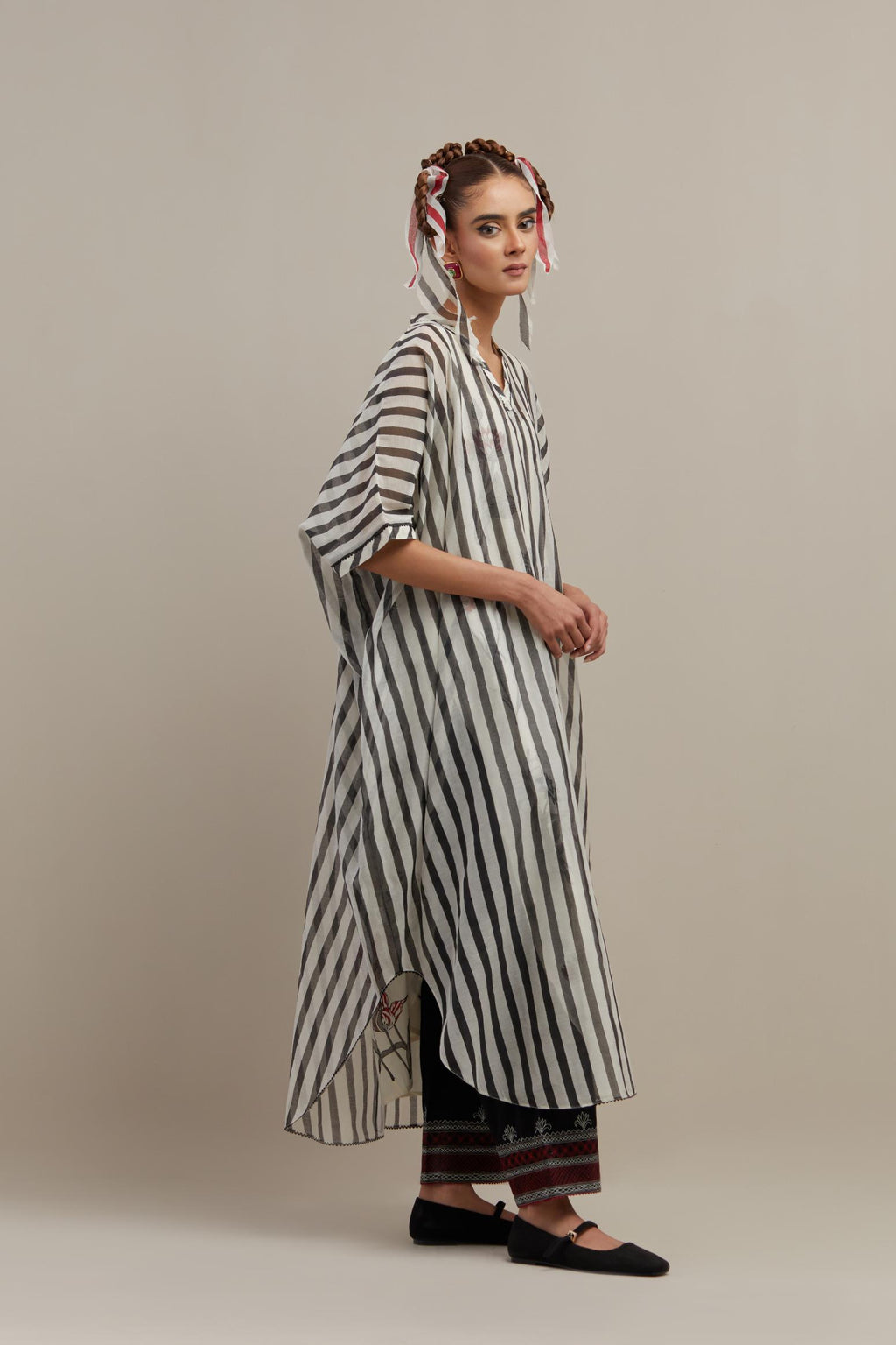 Black & off-white cotton chanderi hand block printed kaftan with round hem, paired with black straight pants with quilted embroidery at bottom hem.