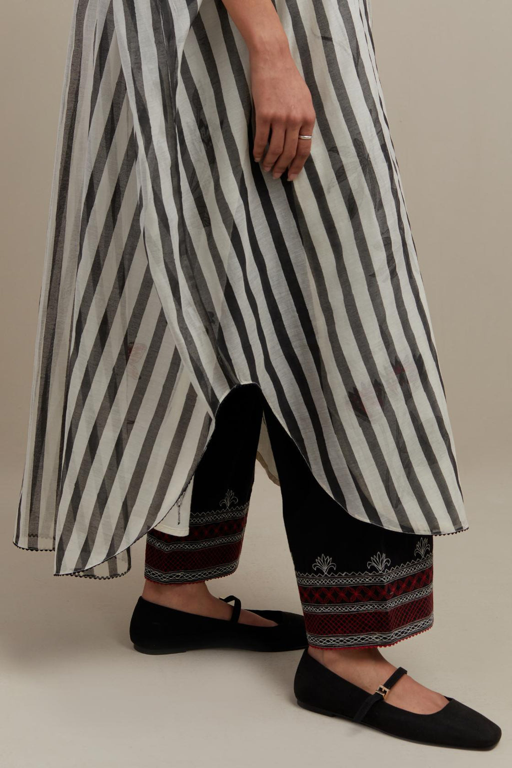 Black & off-white cotton chanderi hand block printed kaftan with round hem, paired with black straight pants with quilted embroidery at bottom hem.