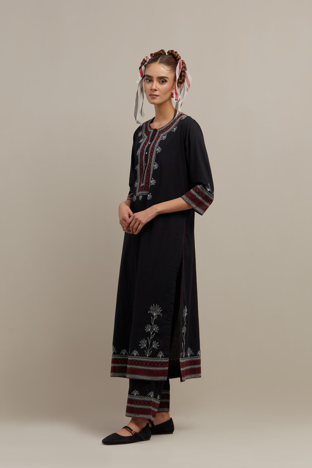 Black cotton straight kurta set with Red & off-white embroidery at neck, hem and sleeves.