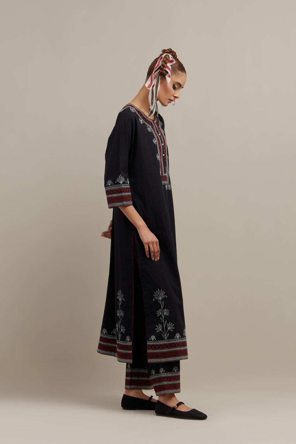 Black cotton straight kurta set with Red & off-white embroidery at neck, hem and sleeves.