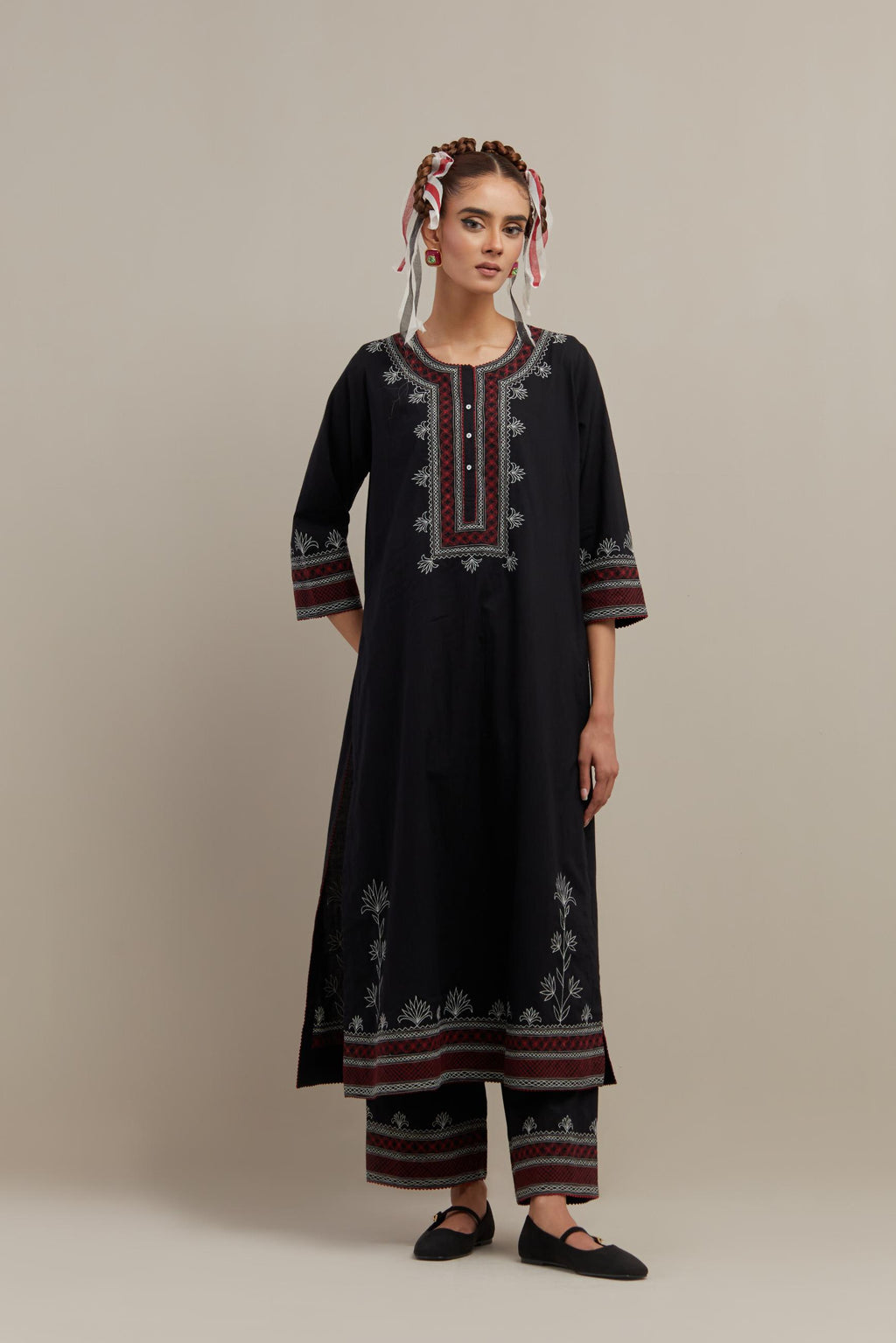 Black cotton straight kurta set with Red & off-white embroidery at neck, hem and sleeves.