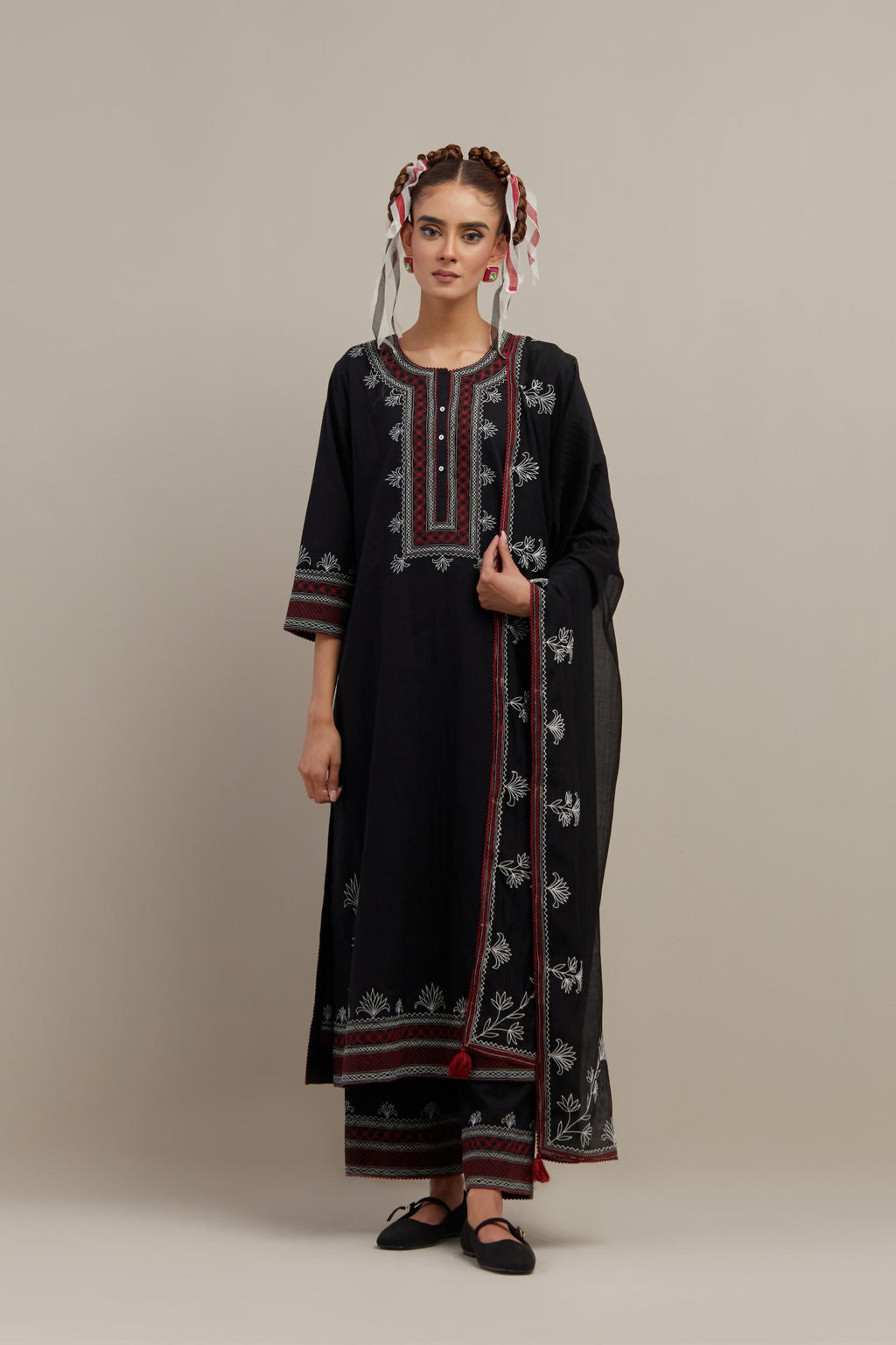 Black cotton straight kurta set with Red & off-white embroidery at neck, hem and sleeves.