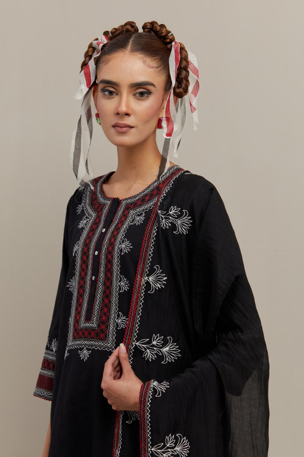 Black cotton straight kurta set with Red & off-white embroidery at neck, hem and sleeves.