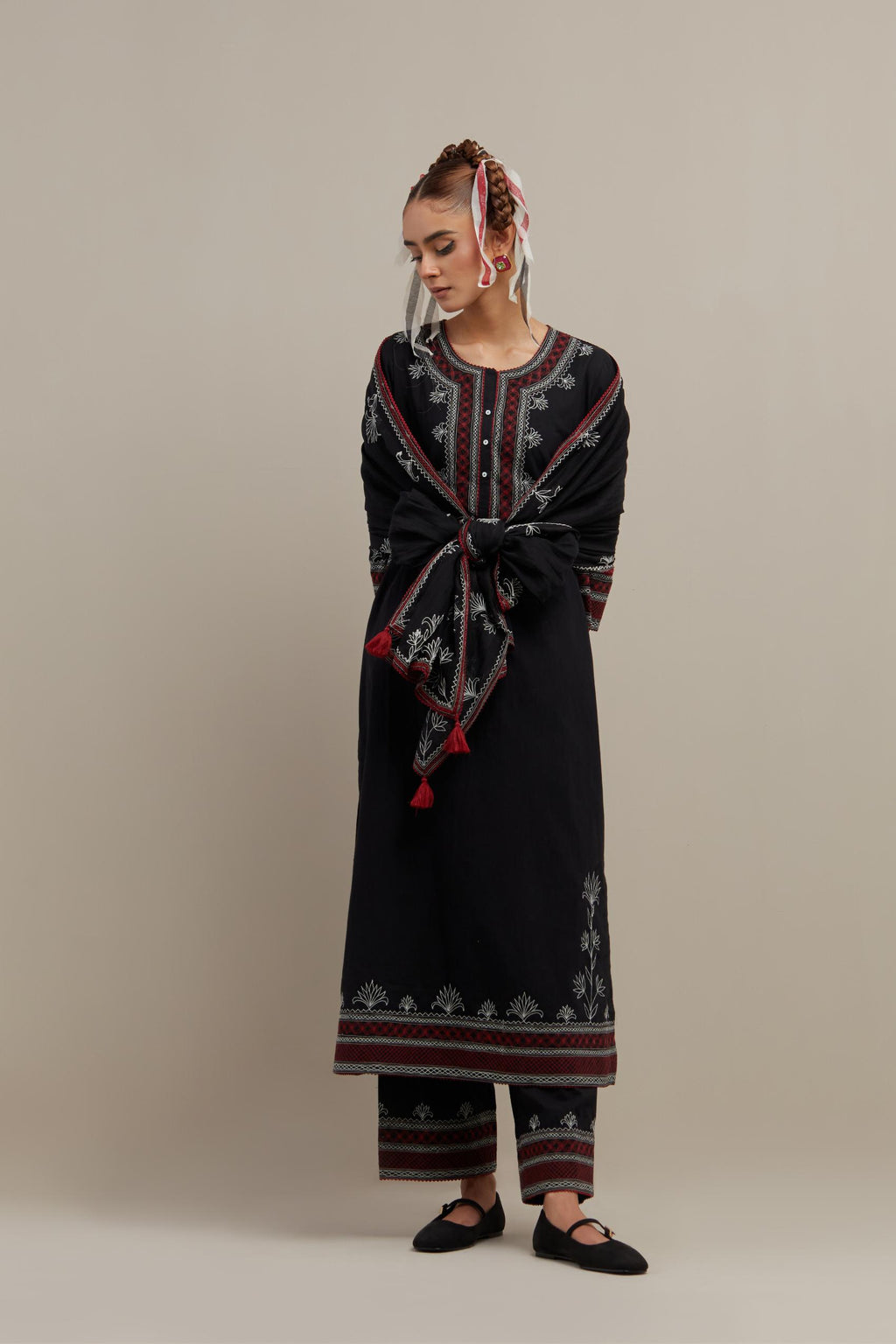 Black cotton straight kurta set with Red & off-white embroidery at neck, hem and sleeves.