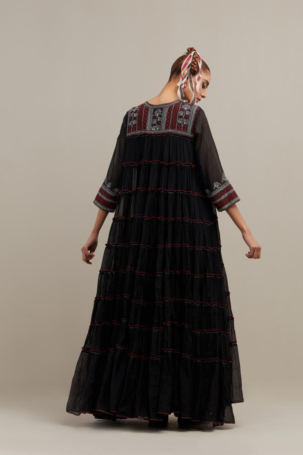 Black cotton chanderi multi-tiered kurta dress set with 3/4 sleeves, highlighted with red & off white quilted embroidered yoke in front and back.