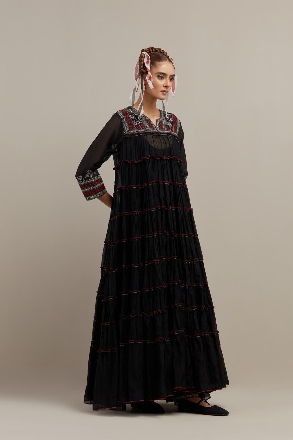 Black cotton chanderi multi-tiered kurta dress set with 3/4 sleeves, highlighted with red & off white quilted embroidered yoke in front and back.