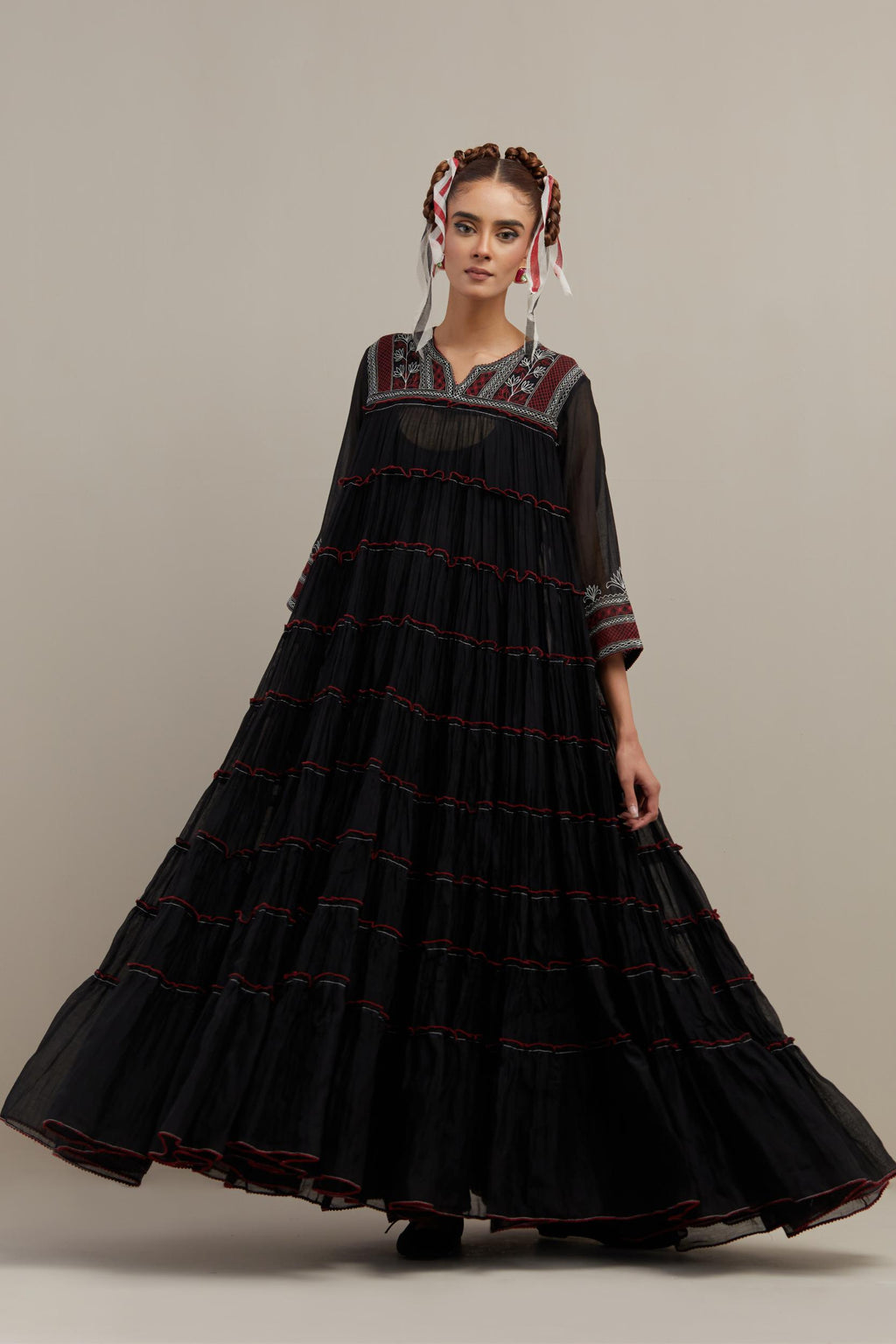 Black cotton chanderi multi-tiered kurta dress set with 3/4 sleeves, highlighted with red & off white quilted embroidered yoke in front and back.