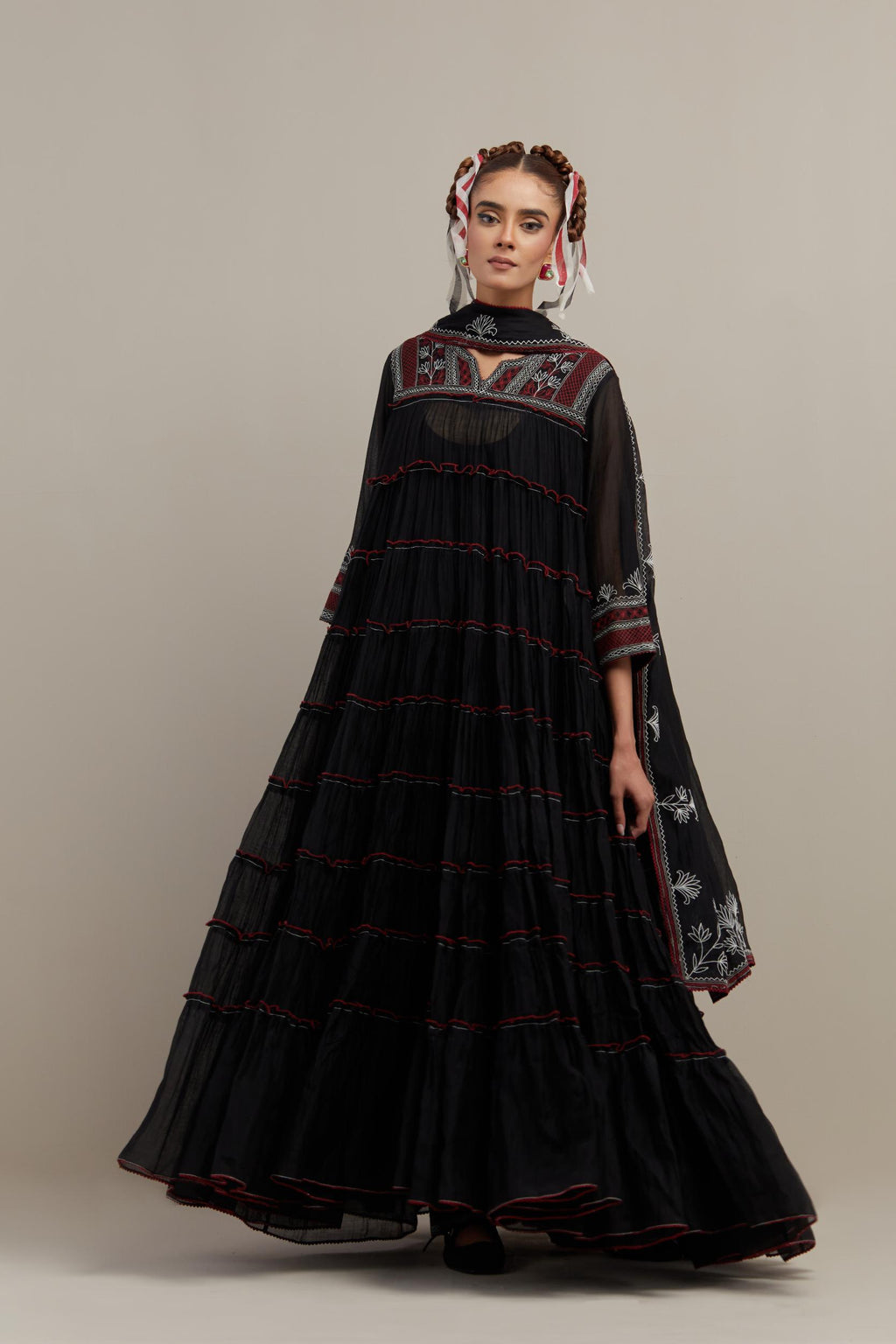 Black cotton chanderi multi-tiered kurta dress set with 3/4 sleeves, highlighted with red & off white quilted embroidered yoke in front and back.