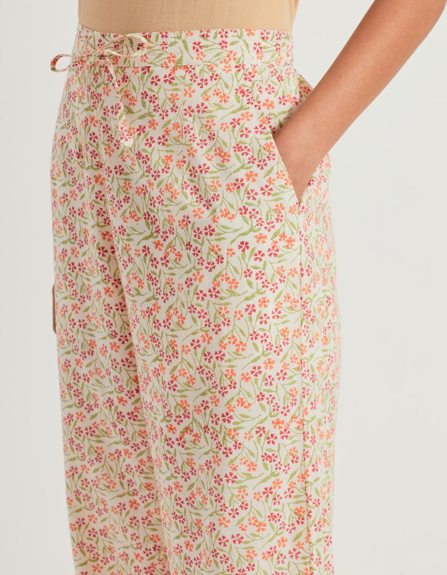 Orange & green cotton straight pants with all-over small flower hand block print.