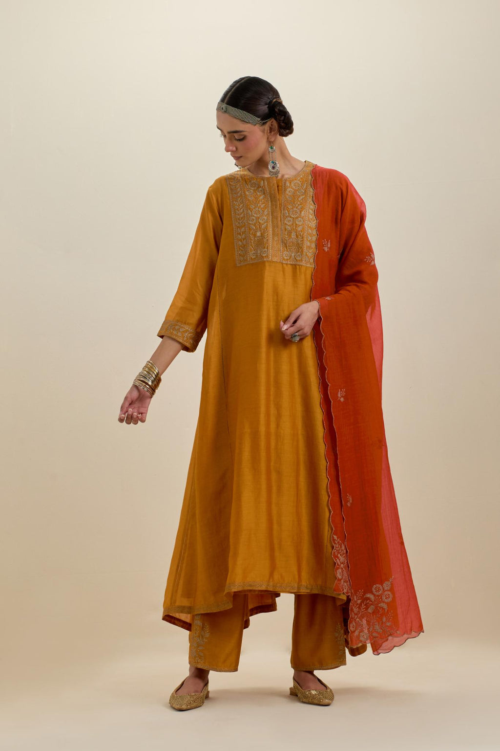 Orange cotton chanderi dupatta with all-over dull gold zari embroidery and scalloped edges.