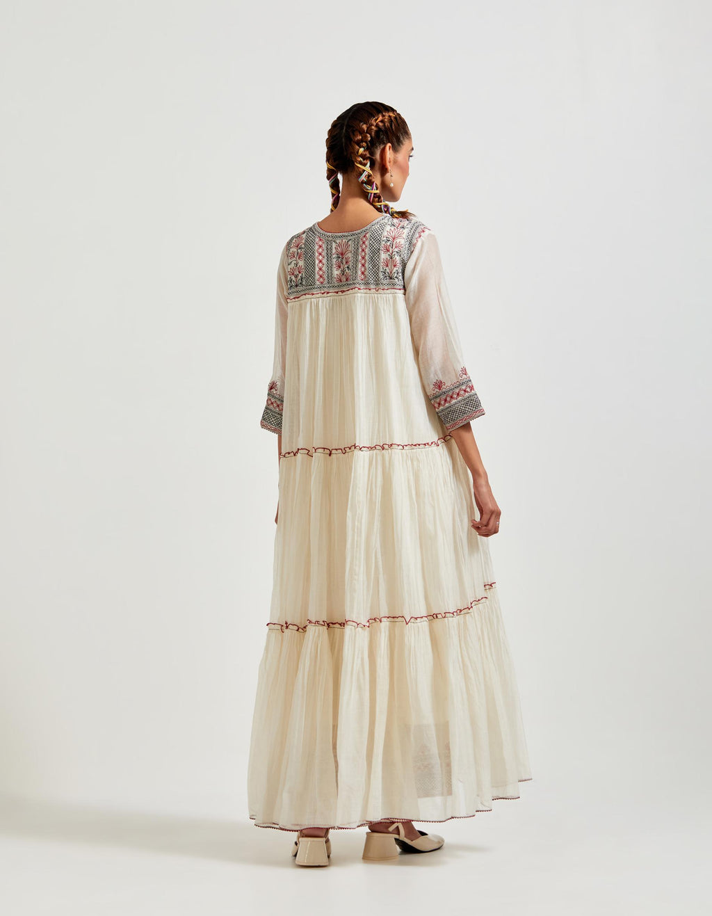 Off white three-tiered cotton chanderi kurta dress set with 3/4 sleeves, highlighted with quilted yoke in front and back.