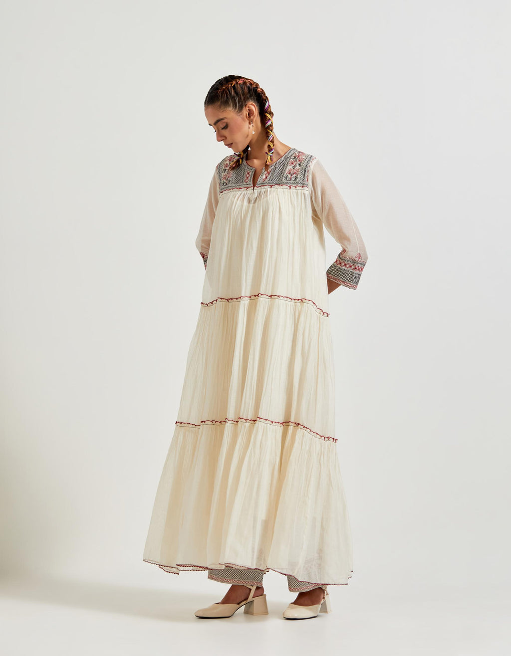 Off white three-tiered cotton chanderi kurta dress set with 3/4 sleeves, highlighted with quilted yoke in front and back.