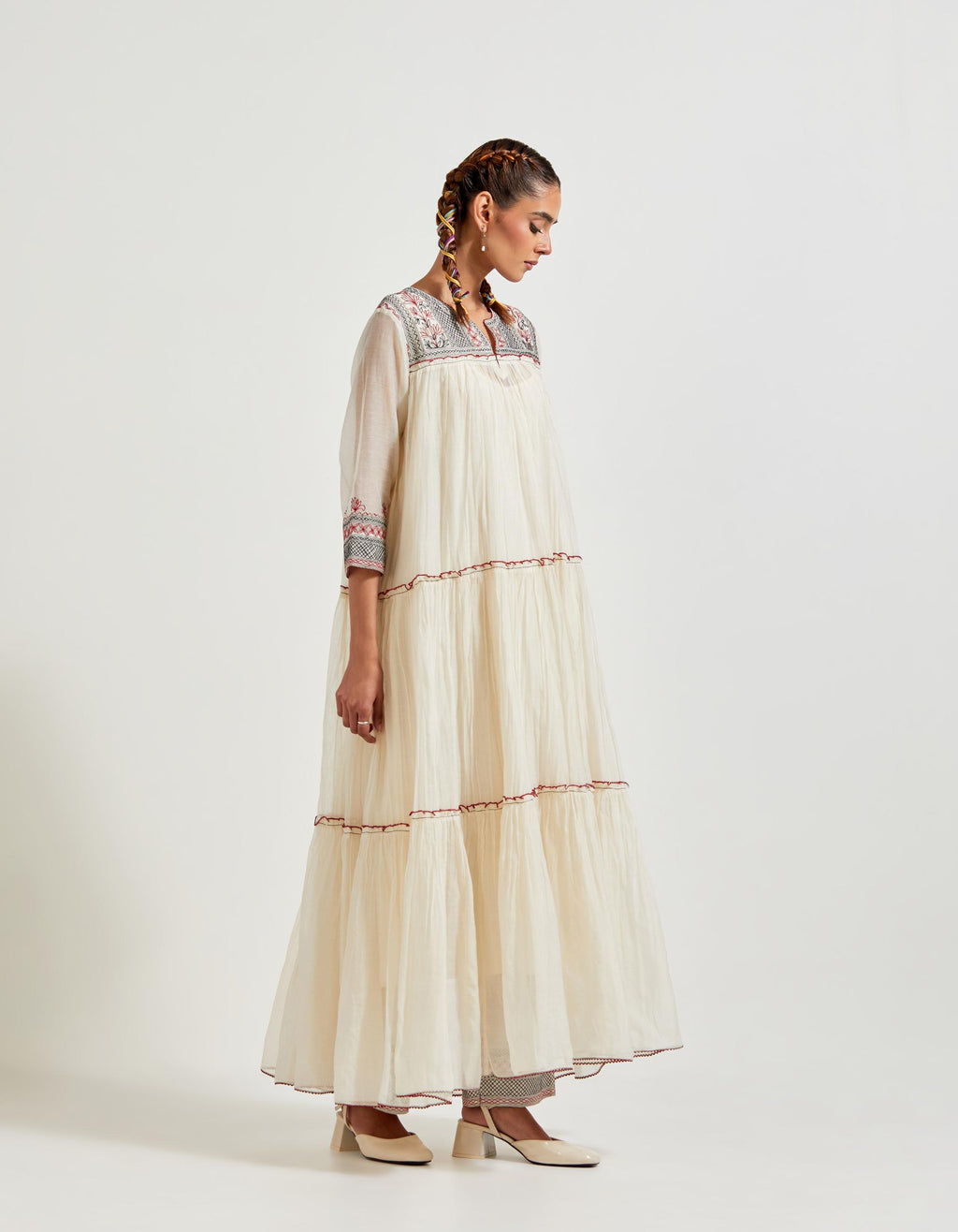 Off white three-tiered cotton chanderi kurta dress set with 3/4 sleeves, highlighted with quilted yoke in front and back.