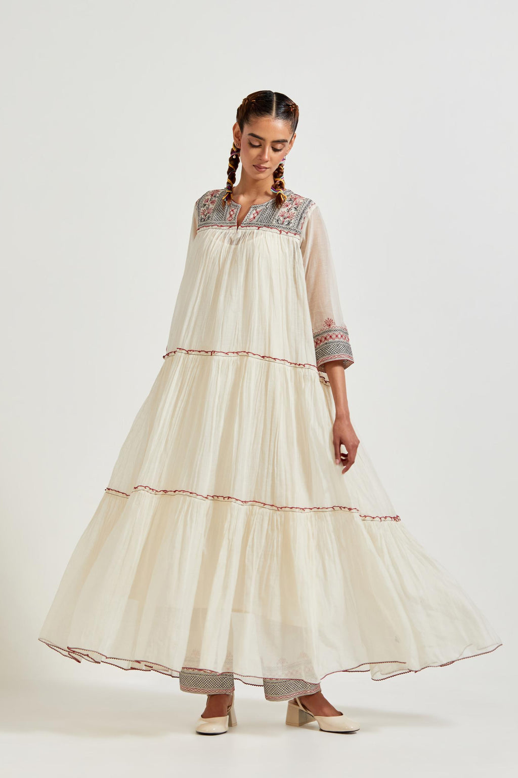 Off white three-tiered cotton chanderi kurta dress set with 3/4 sleeves, highlighted with quilted yoke in front and back.